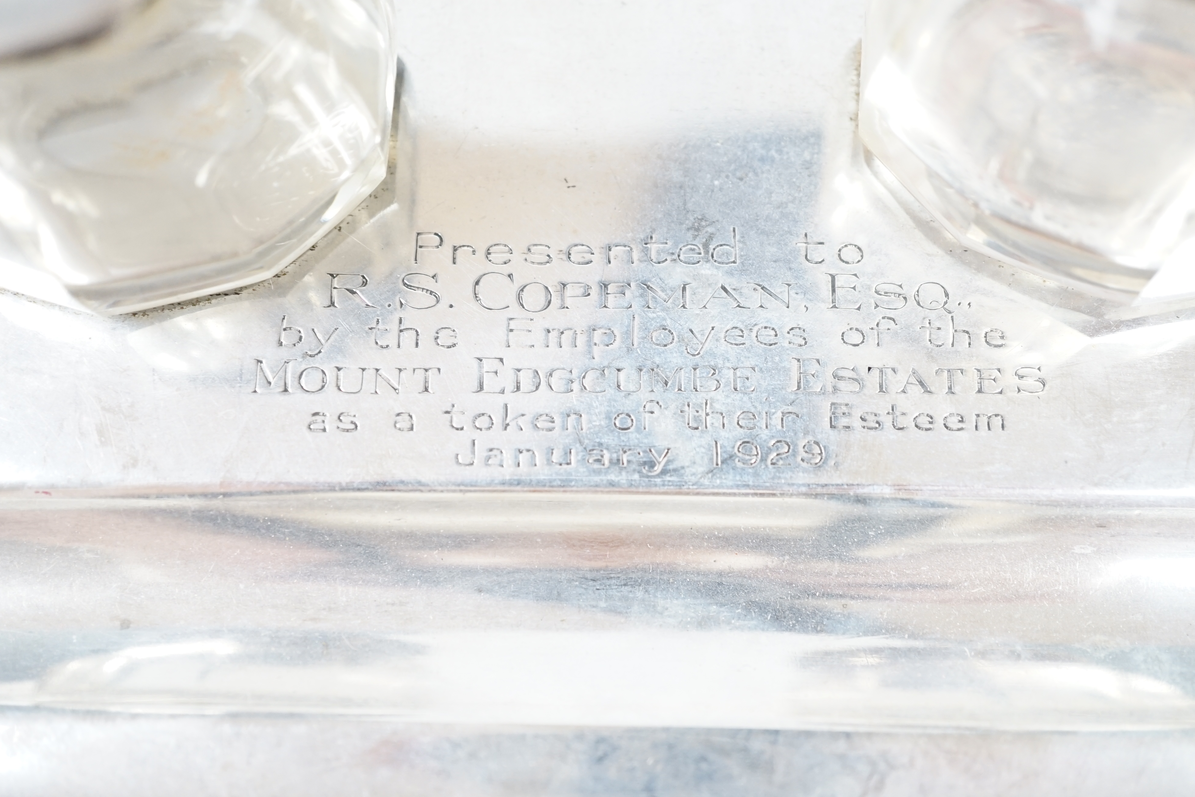 A George V silver inkstand with two silver mounted glass wells, with engraved inscription, S.W. Smith & Co, London, 1921, 21.5cm, 9.6oz. Condition- poor to fair